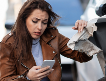 Woman texting after car accident