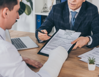 Injured man signing paperwork