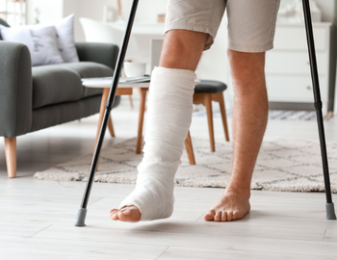 Man walking with crutches and leg cast