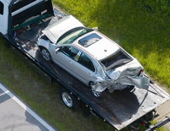 silver car crumpled after a rear-end accident