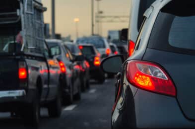 Cars driving very close to one another and tailgating on a highway